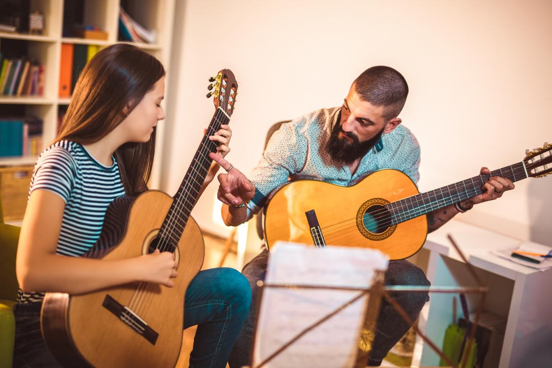 man teaching guitar